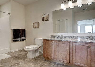 Lancaster apartment bathroom with double sinks and granite counter tops