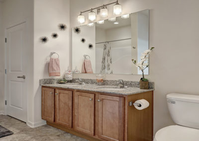 Double sinks and granite counter tops in a Lancaster apartment bathroom